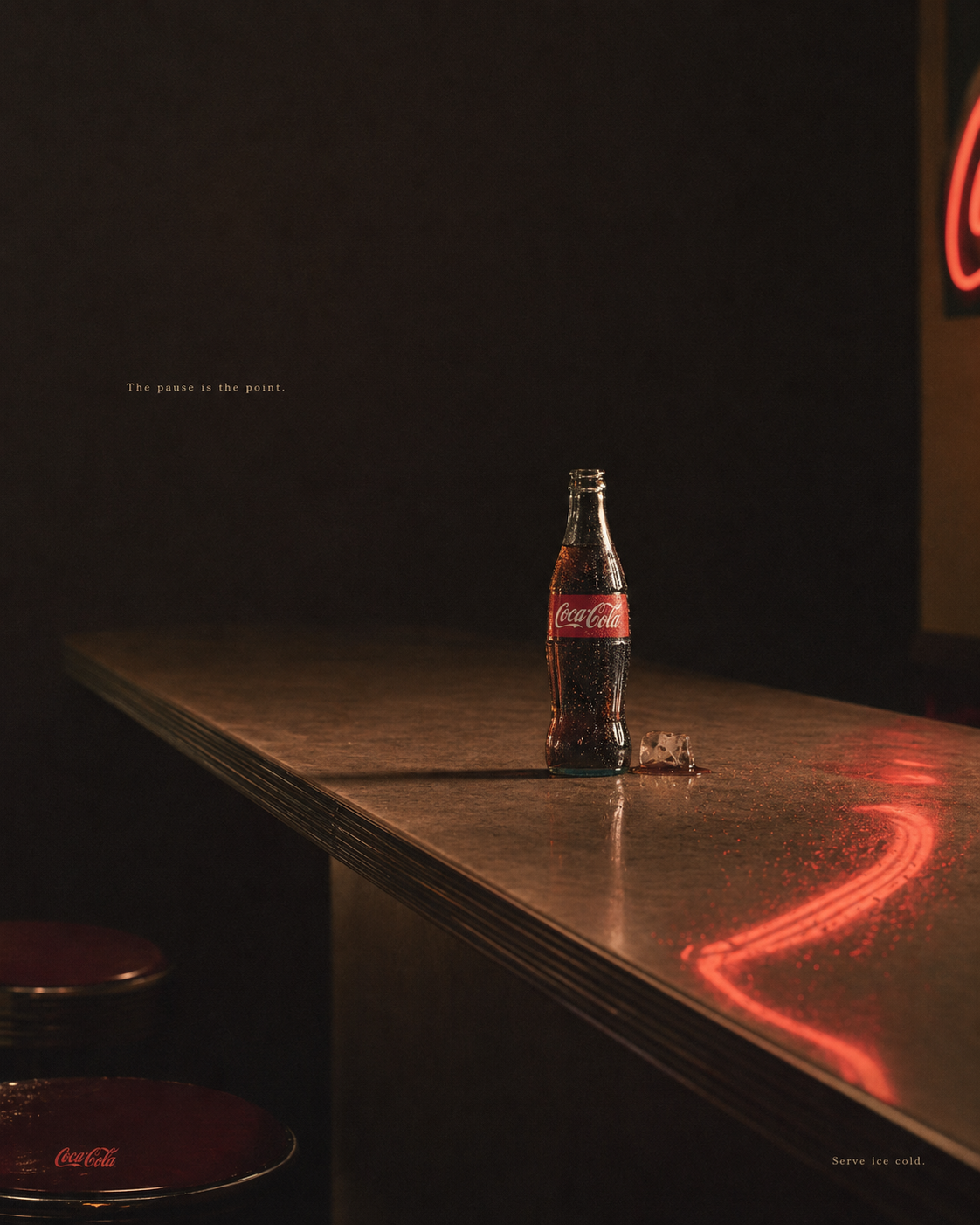 Coca-Cola bottle alone on a polished bar at closing time, neon trace on the wood